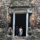 Tourists exit a building at Sambor Prei Kuk.